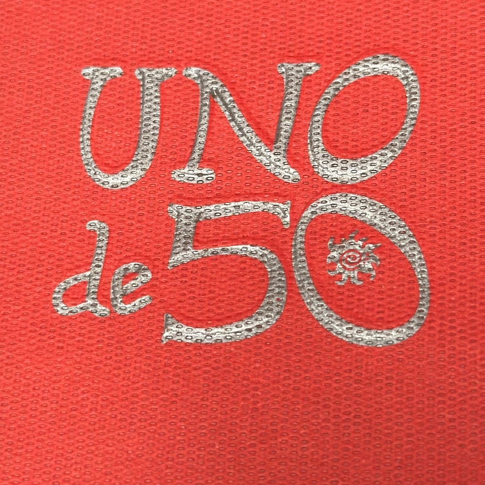Uno de 50 red paper bags in various sizes plus charms